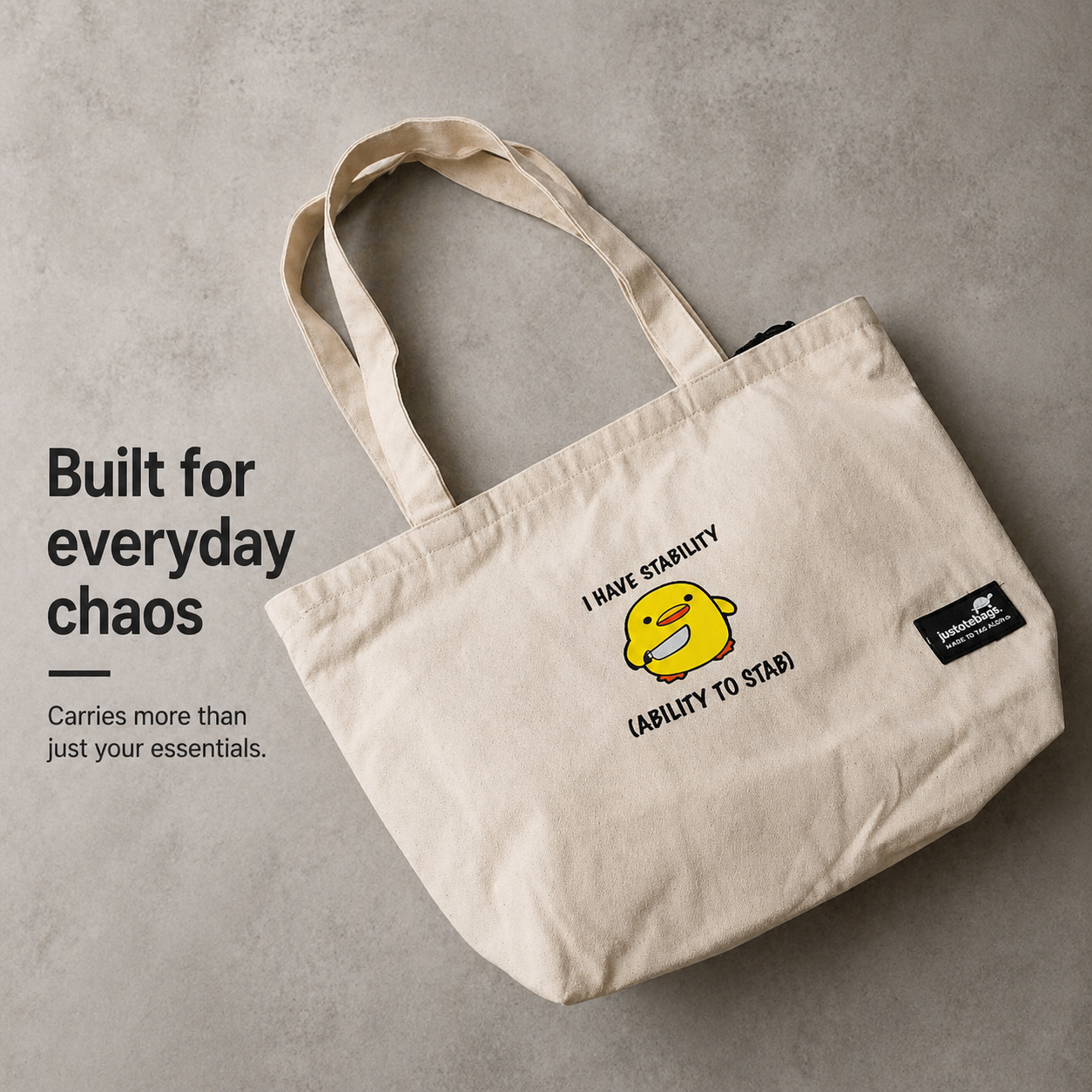Beige tote bag with a cartoon character and text on a gray background